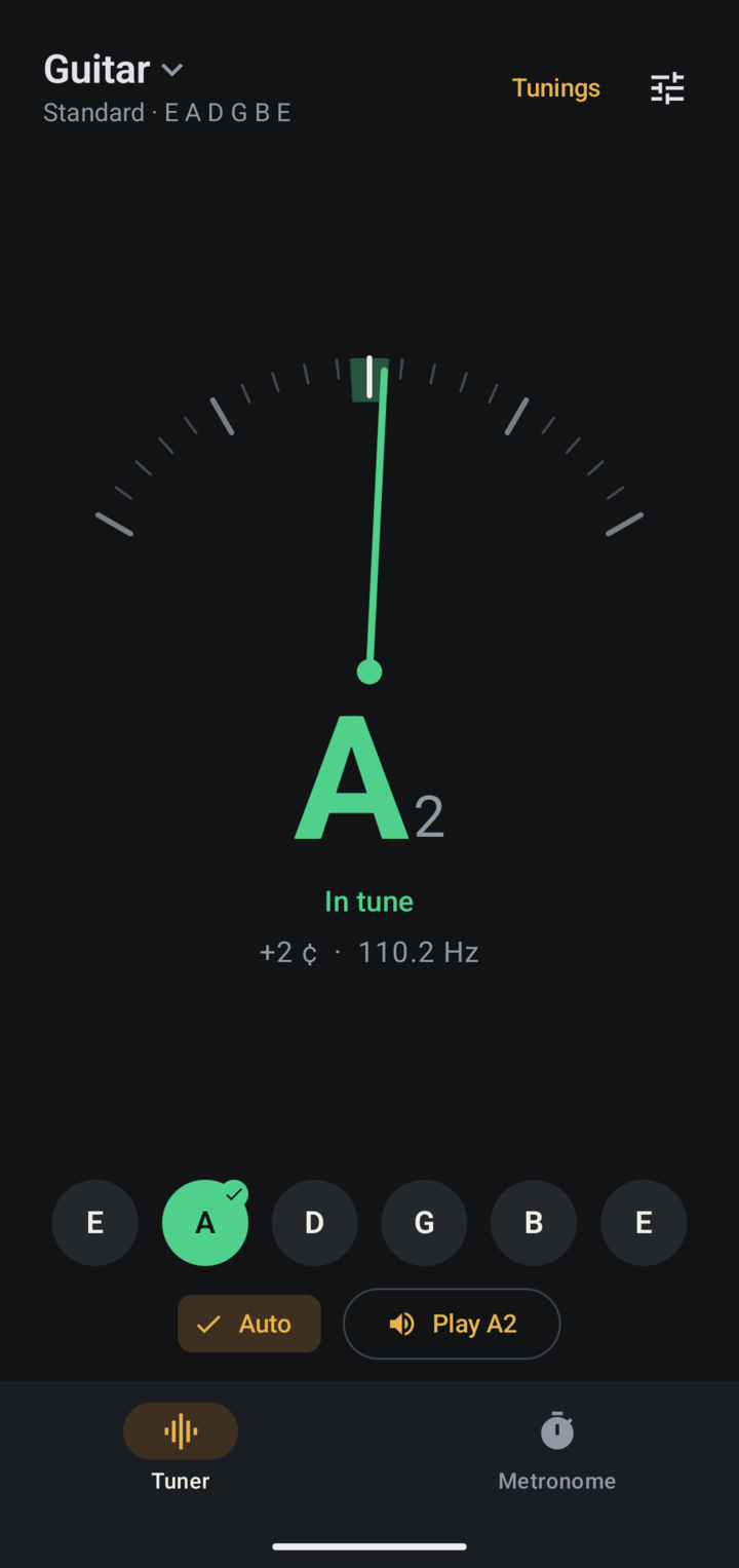 Pegbox tuning a guitar's A string: the needle sits in the green band and the A string button is lit